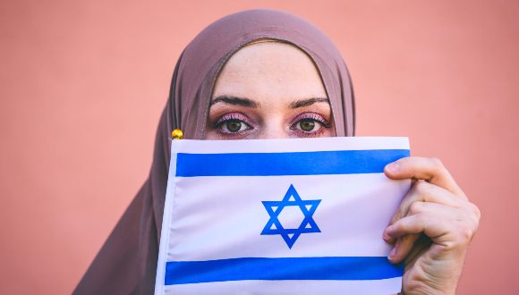 Arabic woman holding an Israeli flag