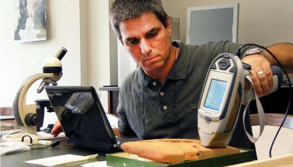 Dr. Yuval Goren examining ancient documents using a mobile XRF device