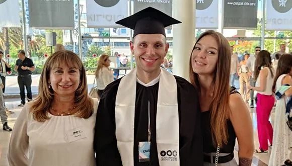 Kirill at his graduation ceremony (from left to right): Sigal Shachar, Kirill Drik and his partner Yulia