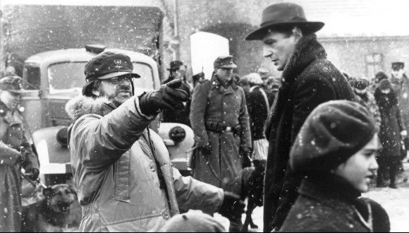 Director Steven Spielberg with cast on the film set of Schindler's List (1993).