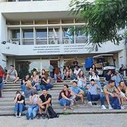 Students sitting on stairs in front of Coller School of Management