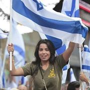 girl with Israeli flag and idf shirt in demonstration